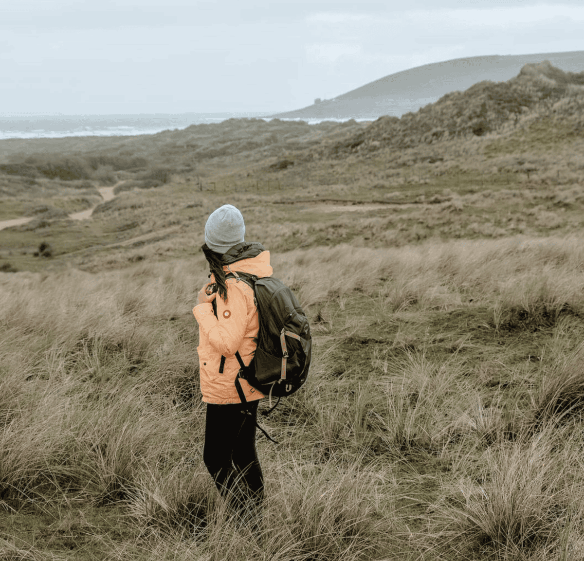 girl in yellow coat in a field