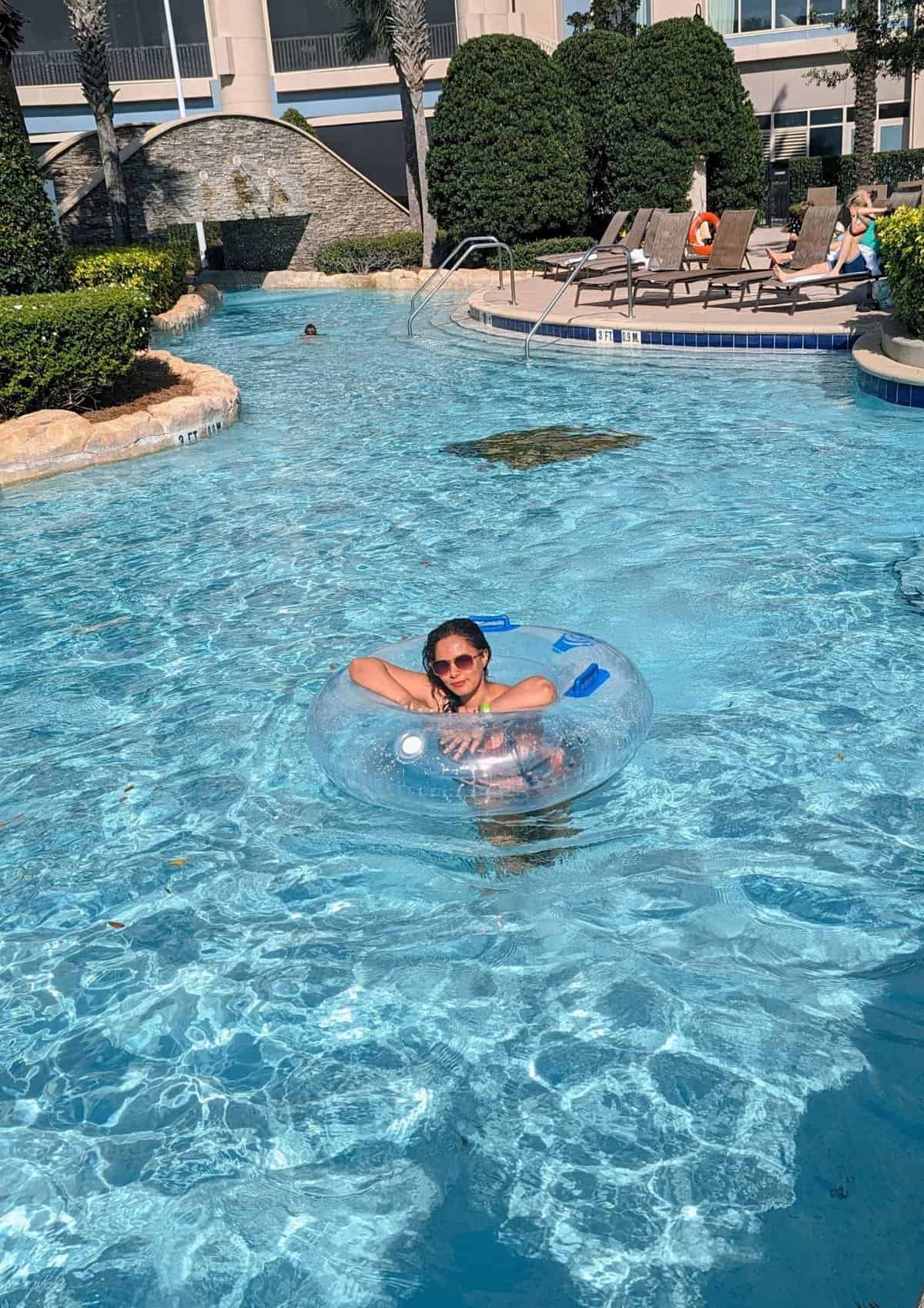 girl floatingl in blue lazy river