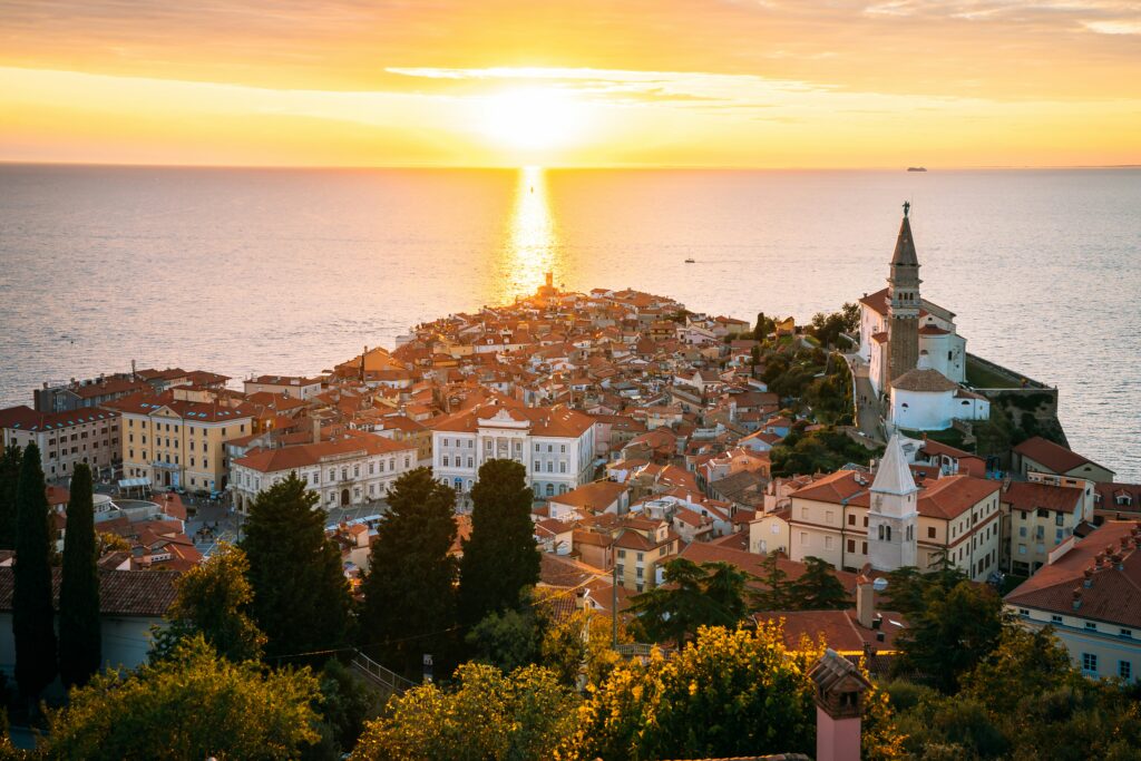 sunset reflections on water, red tiles rooftops