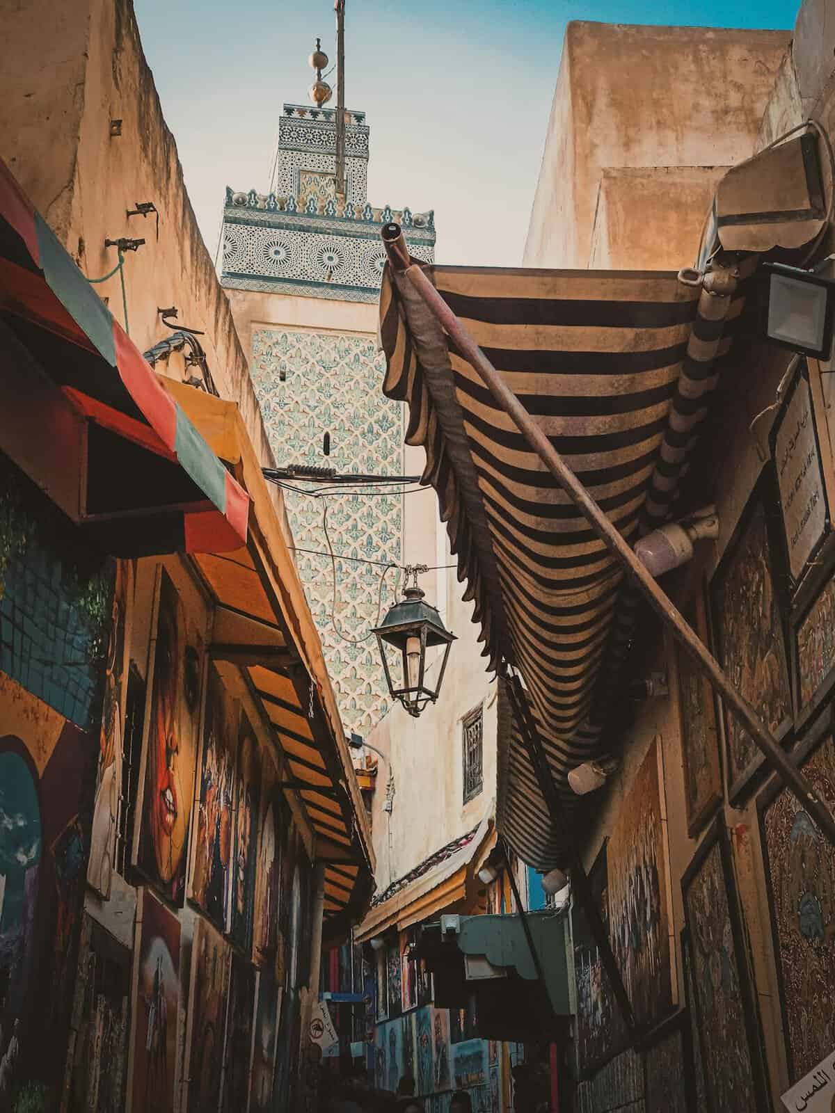 mosque and colourful walls of the medina in Fes, one of 10 best cheapest destinations to visit this autumn. 