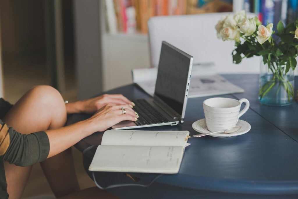 a person typing on a laptop on a table